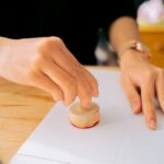 a person using a wooden stamp