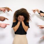 people pointing fingers at a stressed woman